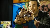 Theodore, Alvin and Simon, along with manager/songwriter Dave Seville (Jason Lee), pose for photographs at a launch party for their new album in "Alvin and the Chipmunks."