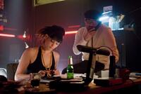 Gemma Arterton as June and Jeremy Piven as Roman in "RocknRolla."