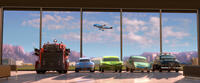 Red, Sally Carrera voiced by Bonnie Hunt, Ramone voiced by Cheech Marin, Flo voiced by Jenifer Lewis, Sheriff voiced by Michael Wallis in "Cars 2."