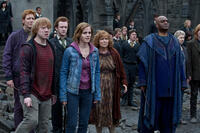 James Phelps as Fred Weasley, Rupert Grint as Ron Weasley, Chris Rankin as Percy Weasley, Emma Watson as Hermione Granger, Julie Walters as Molly Weasley and George Harris as Kingsley Shacklebolt in "Harry Potter and The Deathly Hallows: Part 2."