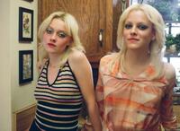 Dakota Fanning as Cherie Currie and Riley Keough as Marie Currie in "The Runaways."