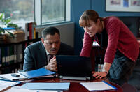 Laurence Fishburne as Dr. Ellis Cheever and Jennifer Ehle as Dr. Ally Hextall in "Contagion."