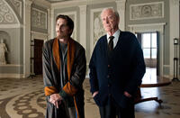 Christian Bale as Bruce Wayne and Michael Caine as Alfred in "The Dark Knight Rises."