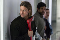 Brad Pitt as Gerry Lane, Pierfrancesco Favino as W.H.O. Doctor and Daniella Kertesz as Segen in "World War Z."