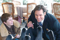 Maxwell Perry Cotton as Billy and Jim Carrey as Tom Popper in "Mr. Popper's Penguins."