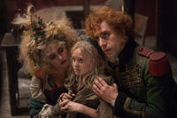 Helena Bonham Carter, Isabelle Allen and Sacha Baron Cohen in "Les Miserables."