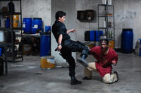 Iko Uwais as Rama and Acip Sumardi as Mad Dog's Man in "The Raid."