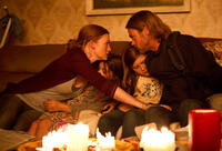 Mireille Enos as Karin Lane, Sterling Jerins as Constance Lane, Abigail Hargrove as Rachel Lane and Brad Pitt as Gerry Lane in "World War Z."