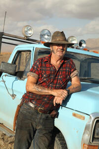 John Jarratt as Mick Taylor
