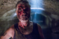 John Jarratt as Mick Taylor
