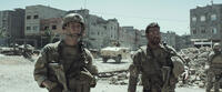 Jake Mcdorman as Biggles and Bradley Cooper as Chris Kyle in "American Sniper."