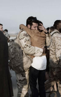 Bradley Cooper as Chris Kyle and Sienna Miller as Taya in "American Sniper."