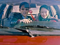 Yi Zhang as Zhang Jinsheng and Tao Zhao as Tao in "Mountains May Depart."