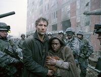 Theo (Clive Owen) protects the pregnant Kee (Clare-Hope Ashitey) in "Children of Men."