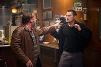 Costello's henchman, French (Ray Winstone), throws Billy Costigan (Leonardo DiCaprio) into a wall after a scuffle with a bar patron in "The Departed."