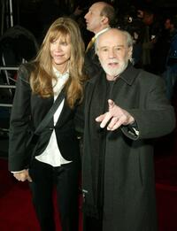 George Carlin and date at the premiere of "Jersey Girl".