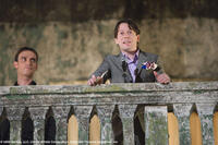 Flanked by Elvis (Anatole Taubman), Dominic Greene (Mathieu Amalric) makes his welcome speech to party guests in "Quantum Solace."