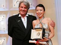 Alain Delon and Do-Yeon Jeon at the 60th International Cannes Film Festival Palme d'Or Award Ceremony.