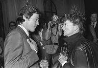 Alain Delon and Katharine Hepburn at the pre-launch cocktail party for his upcoming auction of paintings.