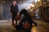 Ethan Cutkosky as Barto and Idris Elba as Father Arthur Wyndham in "The Unborn."