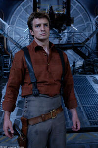 Nathan Fillion as Captain Malcolm Reynolds ponders his next move on an alien craft.