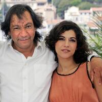 Director Tony Gatlif and Lubna Azabal at the photocall of "Exils" during the 57th Cannes Film Festival.