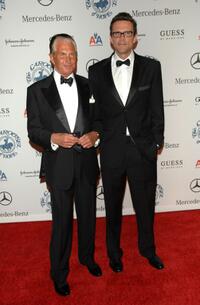George Hamilton and Guest at the 30th anniversary Carousel of Hope Ball.