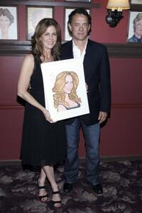 Rita Wilson and Tom Hanks pose with a caricature made in her honor for her Broadway debut in "Chicago."