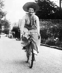 Katharine Hepburn riding a bicycle between scenes of the classic American movie "The African Queen."