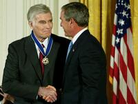 Charlton Heston and U.S. President George W. Bush at an East Room event at the White House.