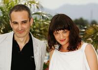 Olivier Assayas and Asia Argento at the photocall of "Boarding Gate" during the 60th International Cannes Film Festival.
