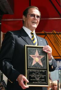 Roger Moore poses after being honored with a Star on the Hollywood Walk of Fame.