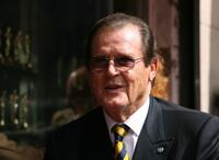 Roger Moore poses after being honored with a Star on the Hollywood Walk of Fame.