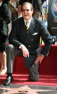 Roger Moore poses after being honored with a Star on the Hollywood Walk of Fame.