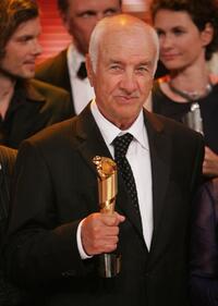 Armin Mueller-Stahl at the German Film Award, holds his Lola Award for Lifetime Achievement.