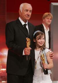 Armin Mueller-Stahl and Zoe Mannhardt at the German Film Award, hold their Lola Awards for Lifetime Achievement and Best Children's Film.