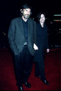 Derrick O'Connor and Guest at the Los Angeles premiere of "End of Days."
