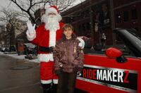 Jansen Panettiere and Santa Claus at the Ridemakerz unveiling of a toy Mini to the Boys and Girls Club.
