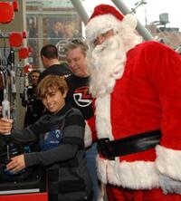 Jansen Panettiere and Santa Clause at the Ridemakerz unveiling of a toy Mini to the Boys and Girls Club.