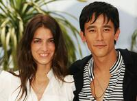 Joana Preiss and Carl Loong NG at the photocall of "Boarding Gate" during the 60th International Cannes Film Festival.