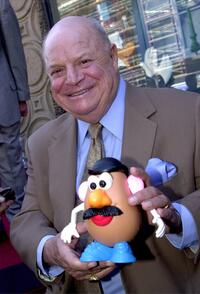 Don Rickles at the Hollywood Walk of Fame, holds a "Mr. Potato Head" doll at a ceremony.
