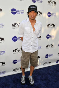 Peter Shinkoda at the "Goodbye cellulite, hello bikini" poolside party in California.