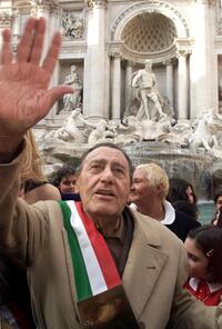 Alberto Sordi waves at the Trevi Foutain in Rome,after throwing his last Italian Lire.
