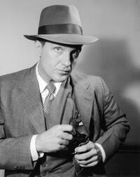 Promotional portrait of actor Robert Stack for the television series "The Untouchables".
