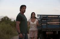 Sylvester Stallone as Barney Ross and Giselle Itie as Sandra in "The Expendables."
