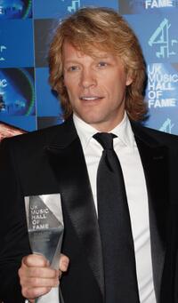 Jon Bon Jovi poses with his inductee trophy in the Awards room at the UK Music Hall Of Fame.