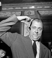 Jacques Tati gestures to the media in Paris.