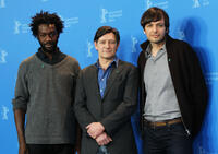 Jean-Christophe Folly, Pierre Bokma and director Ulrich Koehler at the photocall of "Schlafkrankheit" during 61st Berlin International Film Festival.