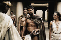 Leonidas (Gerard Butler) warns the Persian Messenger (Peter Mensah) as Captain (Vincent Regan) and Gorgo (Lena Headey) look on in "300."
