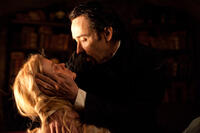 Alice Eve as Emily Hamilton and John Cusack as Edgar Allan Poe in ``The Raven.''